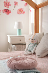 Toy dog on bed in child's room