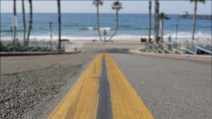 Road with yellow line, pacific ocean beach, Oceanside California USA. Tropical summertime palms,...