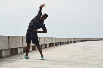 Fototapeta na wymiar African young man exercising during sports training in the morning outdoors