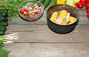 Autumn harvest of vegetables on an old wooden table and an old frying pan.