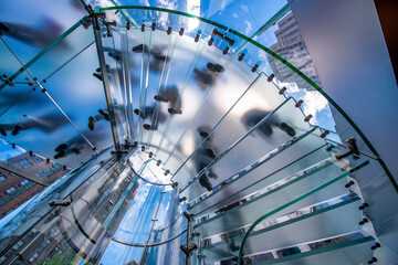 Silhouette people on glass staircase, view from the bottom.Business concept.