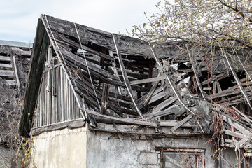 Fototapeta na wymiar Broken roof of an old house.