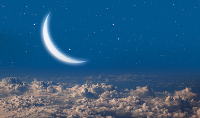 Obraz na płótnie Canvas Night sky with crescent moon over the clouds 