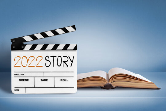 2022 story.Text title on film slate and old book.happy new year concept.