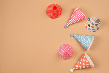 Colorful birthday cap on brown  background.