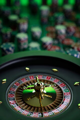 
Casino. Gambling games theme.  Roulette wheel, dice and poker chips on the casino felt green table.
