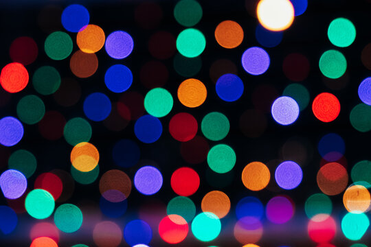 Texture of blurred colored lights on a black background