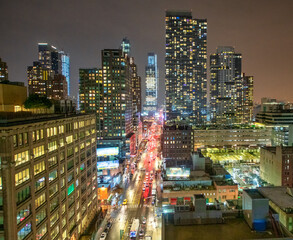 Aerial view of streets and skyscrapers of Midtown at night - New York City.