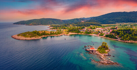 View from flying drone of Saint Nicholas church and Ag. Nikolaos village. Magnificent sunset on...