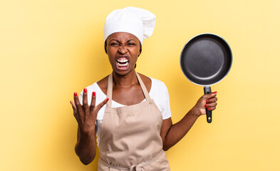 black afro chef woman looking angry, annoyed and frustrated screaming wtf or what’s wrong with you