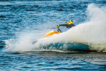 Obraz premium Man riding a Jet Ski in the lake during race