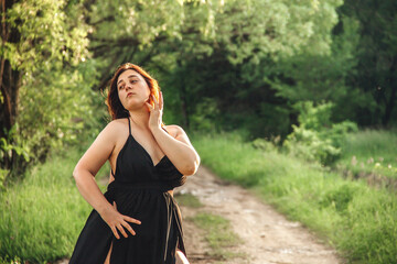 Redhead girl in greenery