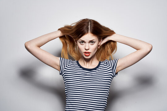 cheerful woman holding hair makeup posing fun fashion expression model studio
