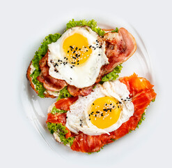 Toast with salmon, bacon and cream cheese.  On a wooden background. Breakfast
