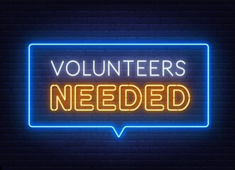 Volunteers needed neon lettering on brick wall background.