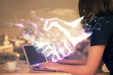 Double exposure of woman hands typing on computer and handshake drawing. Partnership concept.