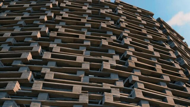 A tower of wooden pallets stacked high on top of each other ready to burn in a bonfire.