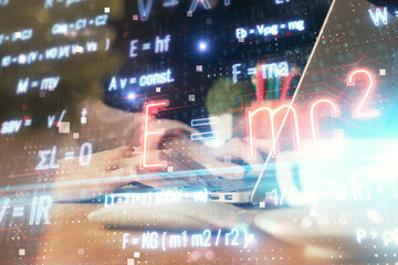 Double exposure of woman hands typing on computer and formula hologram drawing. Education concept.