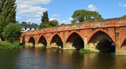 Fototapeta premium Great Barford Packhorse Bridge and Church Bedfordshire England.