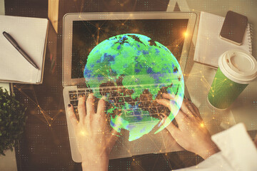 Double exposure of woman hands typing on computer and social network theme hologram drawing. People media concept.