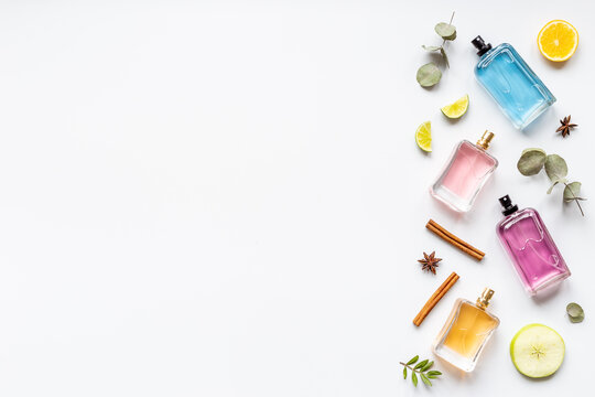 Set of perfume bottles with fragrance spaces and fruits
