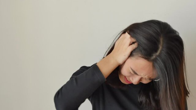 Stressed and burnout young woman having migraine headache