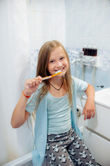 girl brushing her teeth in the bathroom