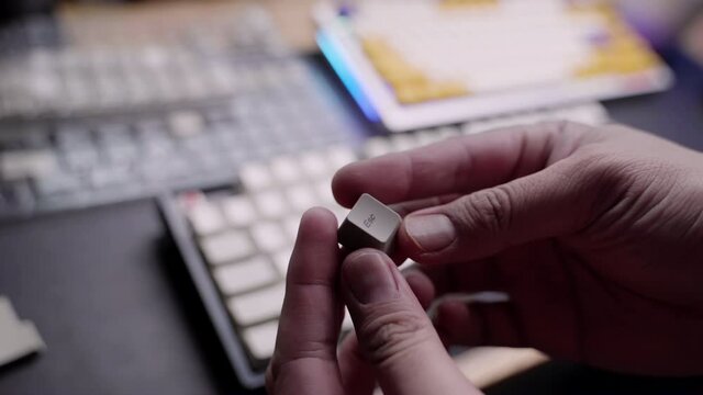 Footage of A man hand doing switching or swaping keycaps for his mechanical gaming keyboard.