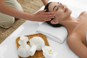 Obraz na płótnie Canvas Young woman receiving facial massage in spa salon