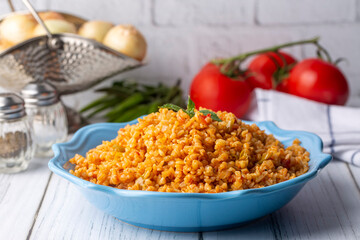Traditional turkish bulgur pilaf with tomato sause in plate (Turkish name; meyhane pilavi)