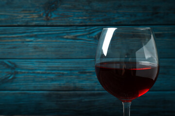 Glass of red wine on rustic wooden background