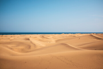 Fototapeta na wymiar Canary dunes with people walking