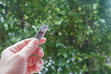 close up people hold stainless nail cutter with left hand for beauty