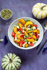 Pumpkin salad with cheese, tomatoes and pumpkin seeds