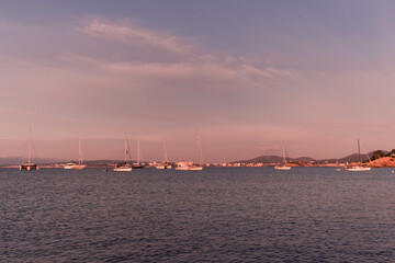 Fototapeta premium Sunset between boats and yachts on Illetes beach in Majorca, Balearic Islands, Spain