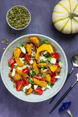 Pumpkin salad with cheese, pumpkin seeds and mini tomatoes