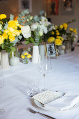 Table set with yellow roses for a festive party