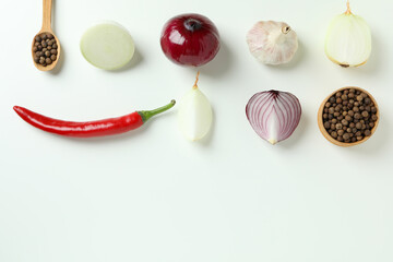 Flat lay with spicy vegetables on white background