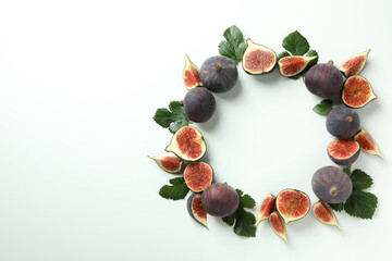 Fig with leaves on white background, space for text