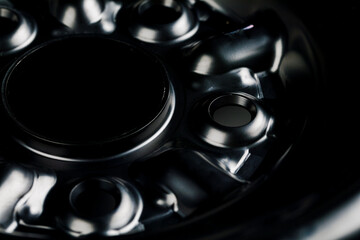 The black element of the car disk. Car wheel close-up.