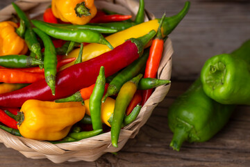 Colorful hot peppers on wooden background