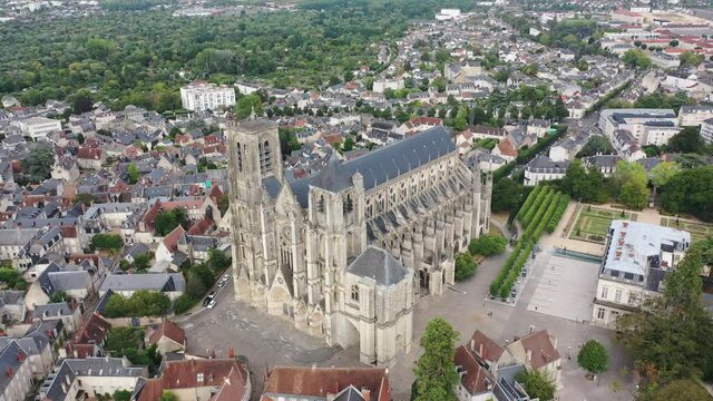 View from drone of houses and ancient Roman Catholic Cathedral of Bourges town at summer day, France