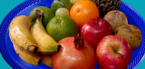 Healthy fruits apple, banana, sweet lime, orange, pomegranate and Gooseberry and other some fruits in a plate