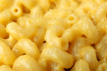 Macaroni with cheese all over background, close up