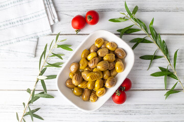 Grilled green olives. Tasty organic green olives in the plate.