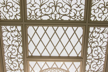 carved ceiling with lighting in light colors