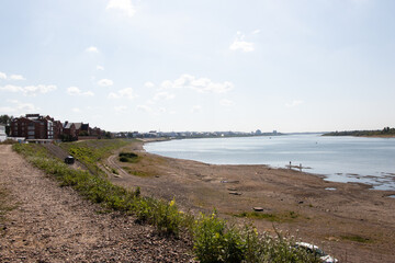 embankment of the tom river at the end of summer. Pebble river bank