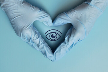 The drawing of the eye is in the hands of a medical professional. A symbol of protection and...