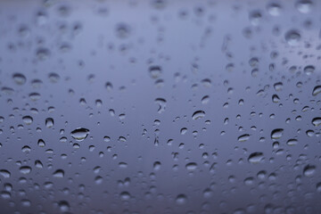 Defocused abstract background of raindrops on windshield car after rain