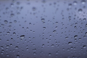Defocused abstract background of raindrops on windshield car after rain